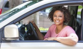 Beautiful young mixed race black African American woman driving a car
